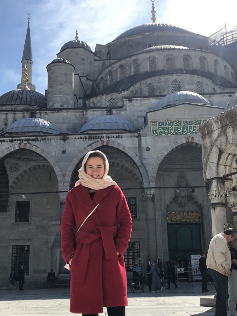 Travel girl standing in front of the stunning Blue Mosque in Istanbul, Turkey