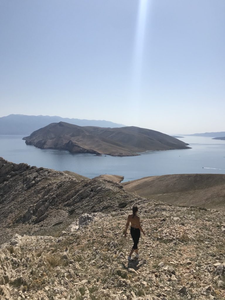 A girl hiking in Baška, Island Krk with a view of Island Prvić