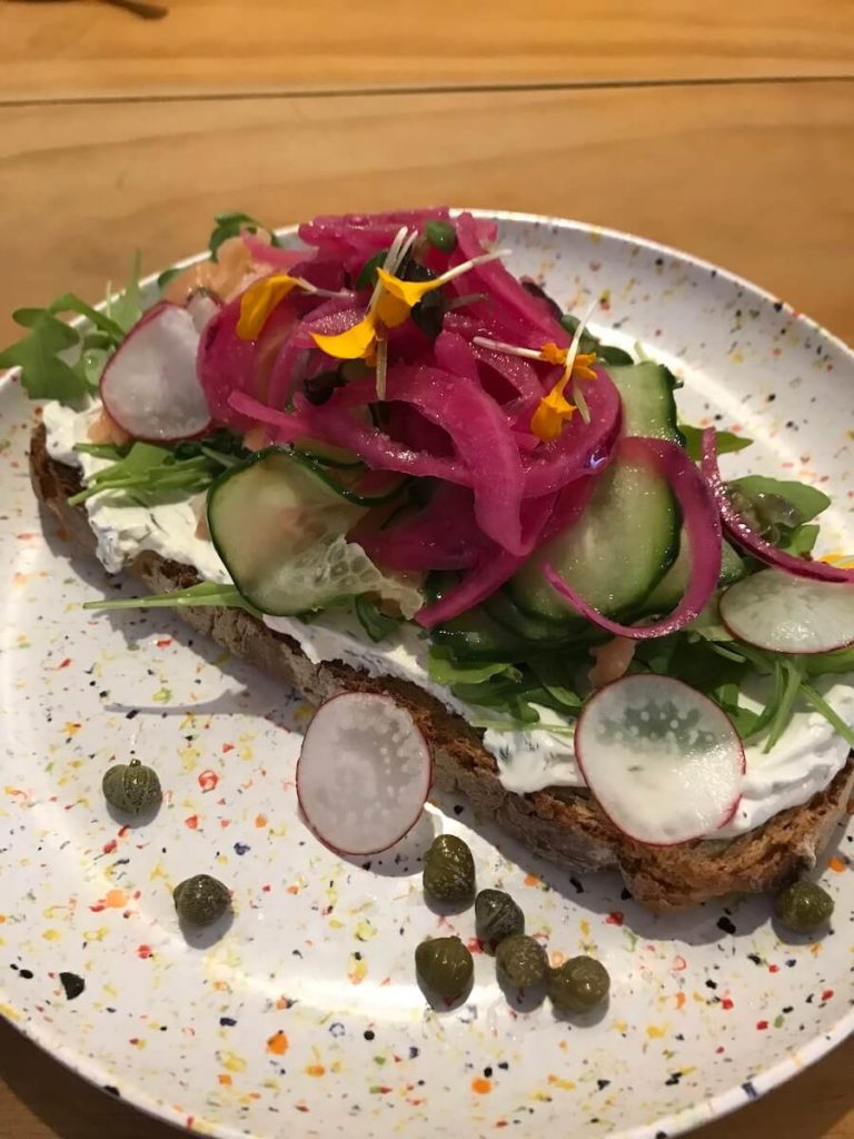 Brunch tostada with pickles and pickled onion in Bluebell Coffee Roasters.